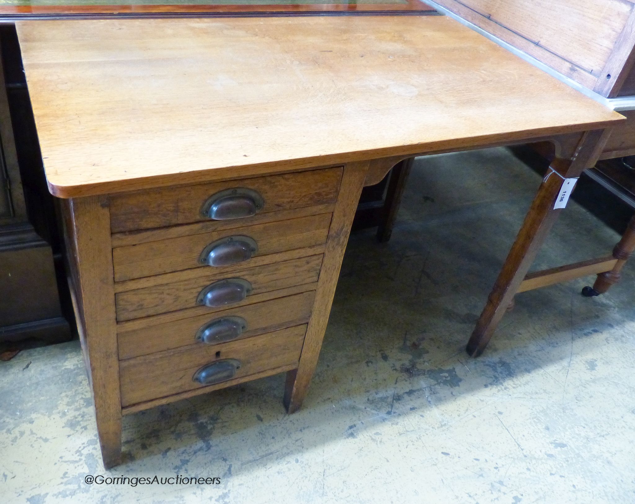 A 1940's oak kneehole desk, stamped G.R. W-107, D-59, H-73cm.